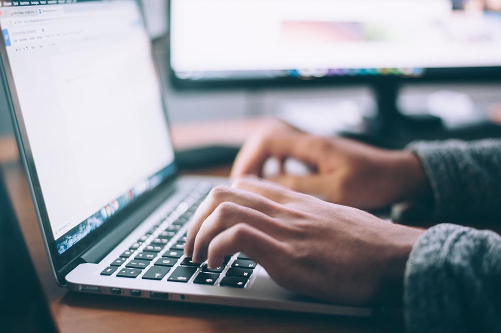 close up of a person using a laptop to browse the internet