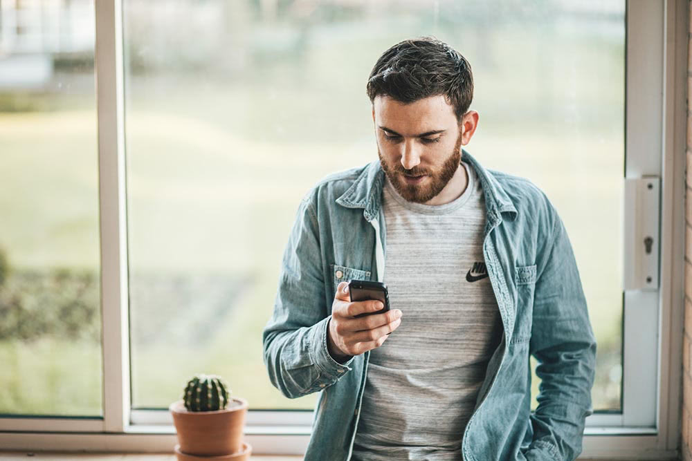 man browsing the internet on a smartphone