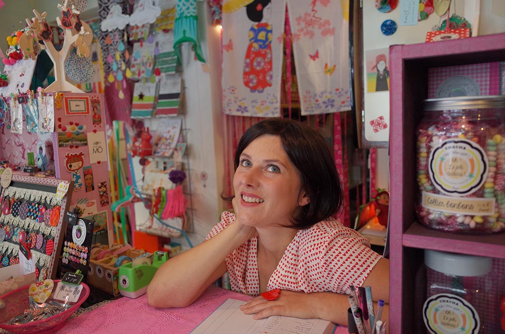 female craft shop owner, sat behind her stall
